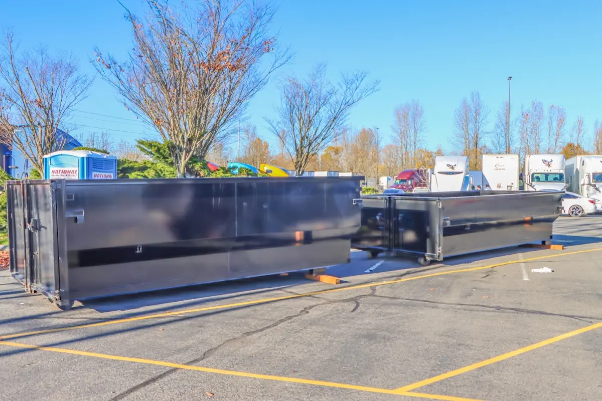 Professional dumpster rental service with roll-off container on residential driveway in Springboro